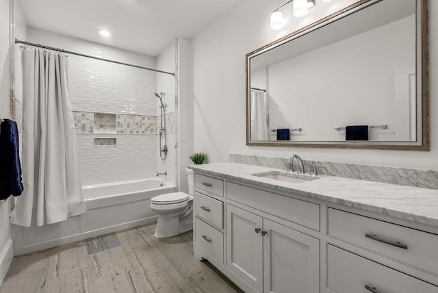 full bathroom featuring vanity, wood-type flooring, toilet, and shower / bath combo with shower curtain