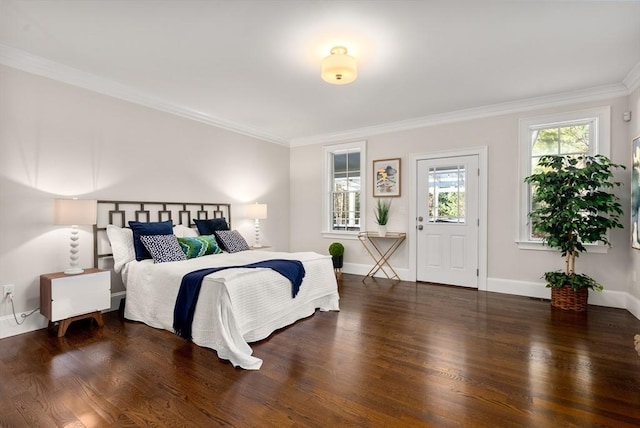 bedroom with ornamental molding and dark hardwood / wood-style floors