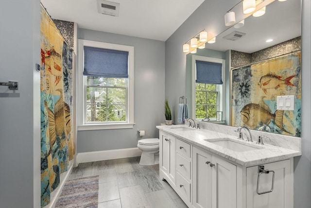 bathroom with vanity, curtained shower, and toilet