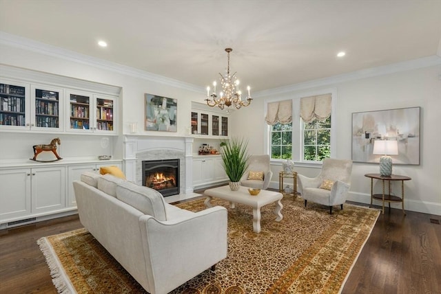 interior space with a high end fireplace, dark wood-type flooring, ornamental molding, and a chandelier