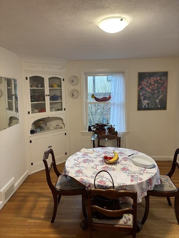 14 Anderson Ave, Holyoke, MA 01040 - dining space with a textured ceiling and dark wood finished floors