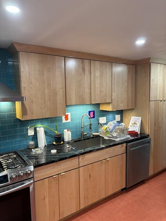 14 Anderson Ave, Holyoke, MA 01040 - kitchen with stainless steel appliances, light brown cabinets, dark stone countertops, decorative backsplash, and a sink