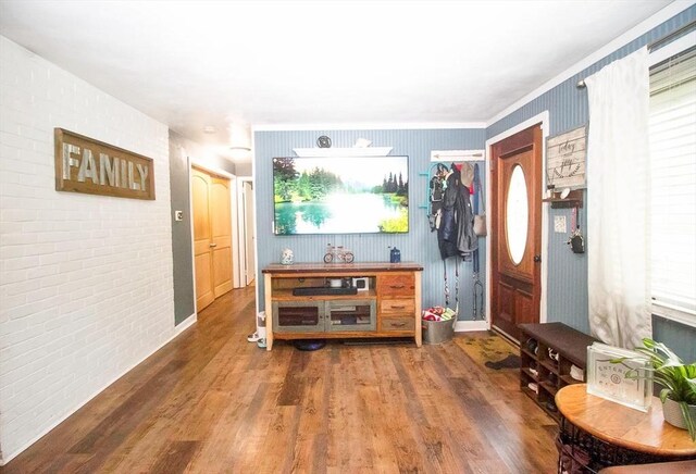 foyer entrance with wood finished floors and baseboards