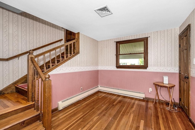 18 Patriot Rd, Tewksbury, MA 01876 - staircase featuring wood-type flooring, a baseboard radiator, and wallpapered walls