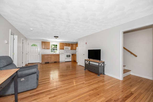 18 Patriot Rd, Tewksbury, MA 01876 - living area featuring light wood-style flooring, stairs, and baseboards