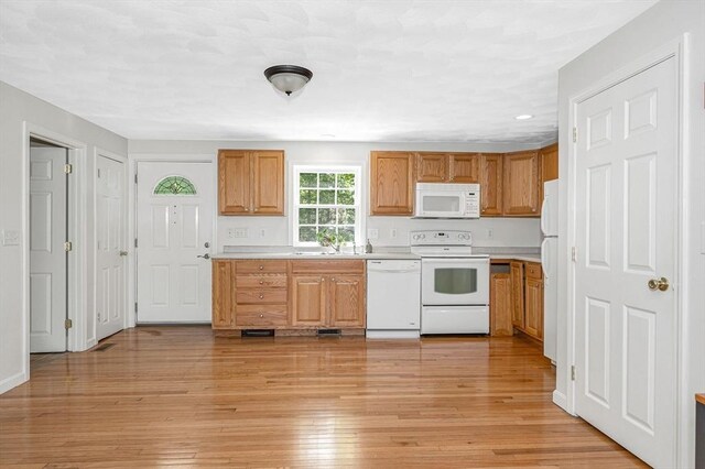 18 Patriot Rd, Tewksbury, MA 01876 - kitchen featuring white appliances, light countertops, light wood-type flooring, a sink, and recessed lighting