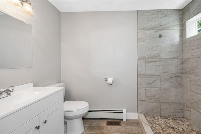 18 Patriot Rd, Tewksbury, MA 01876 - bathroom with baseboard heating, vanity, toilet, tiled shower, and baseboards