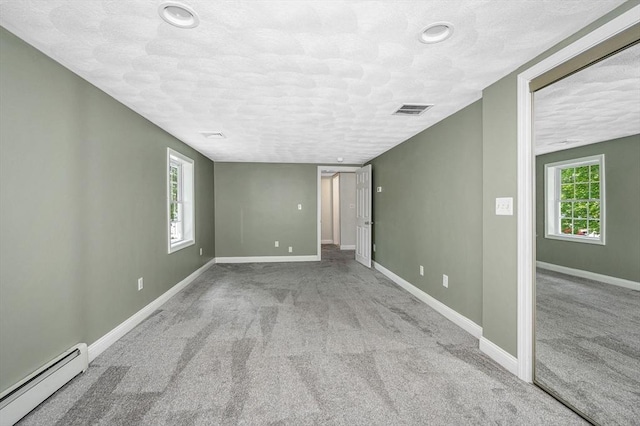 18 Patriot Rd, Tewksbury, MA 01876 - carpeted spare room with baseboard heating, baseboards, a textured ceiling, and recessed lighting