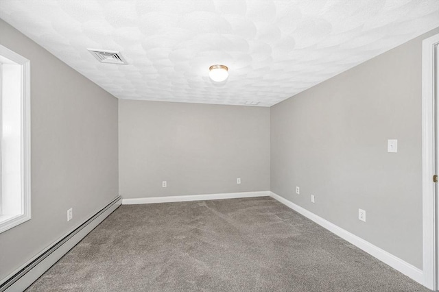 18 Patriot Rd, Tewksbury, MA 01876 - carpeted empty room with a baseboard heating unit and baseboards