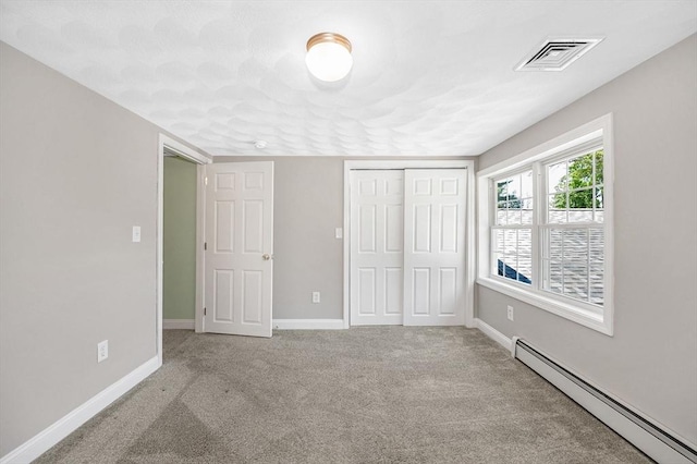 18 Patriot Rd, Tewksbury, MA 01876 - unfurnished bedroom featuring a baseboard radiator, carpet, and baseboards