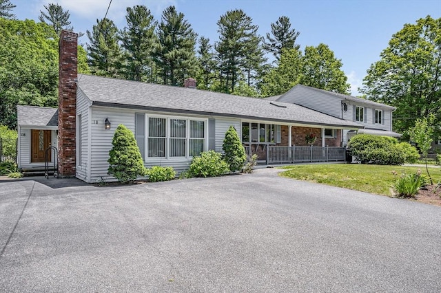 18 Patriot Rd, Tewksbury, MA 01876 - split level home featuring a chimney and a front yard