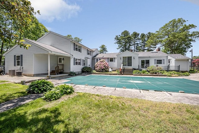 18 Patriot Rd, Tewksbury, MA 01876 - back of property featuring a covered pool, a yard, central AC unit, and a patio area