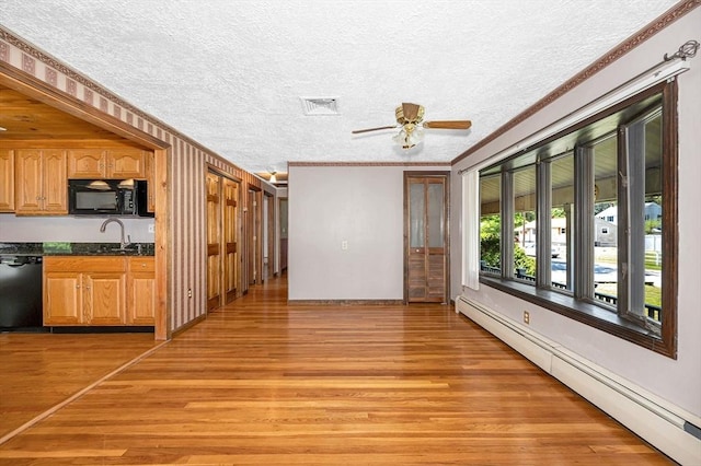 18 Patriot Rd, Tewksbury, MA 01876 - unfurnished living room featuring baseboard heating, crown molding, light wood finished floors, a textured ceiling, and ceiling fan