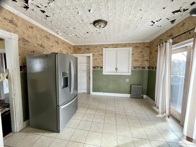 kitchen featuring ornamental molding, radiator heating unit, white cabinets, and stainless steel fridge with ice dispenser