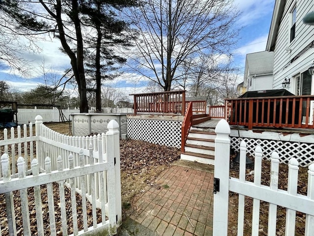 exterior space featuring fence private yard and a wooden deck