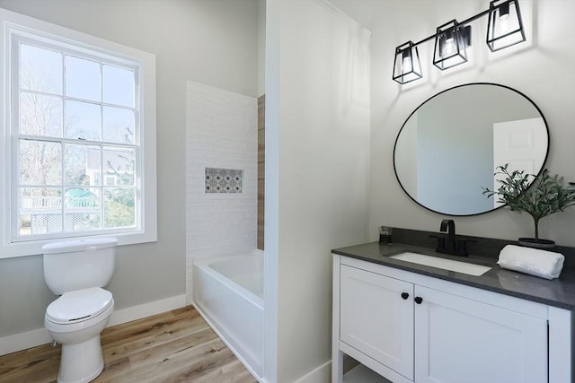 full bathroom featuring vanity, hardwood / wood-style flooring, toilet, and tub / shower combination