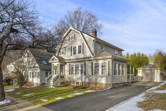 view of front facade featuring a front lawn, an outdoor structure, and a garage