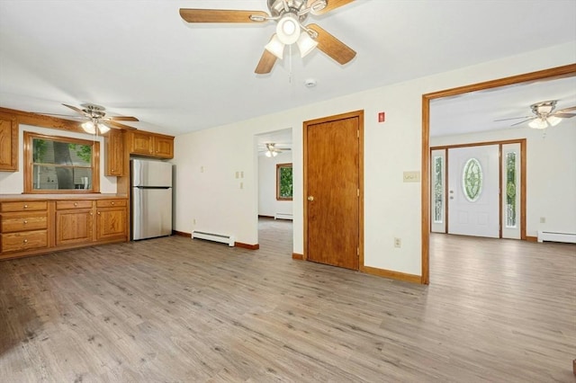 45 Dillon St, Worcester, MA 01604 - unfurnished living room with a baseboard heating unit, ceiling fan, and light wood-type flooring