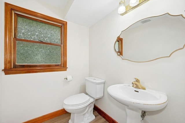 45 Dillon St, Worcester, MA 01604 - half bathroom with baseboards, wood finished floors, toilet, and a sink