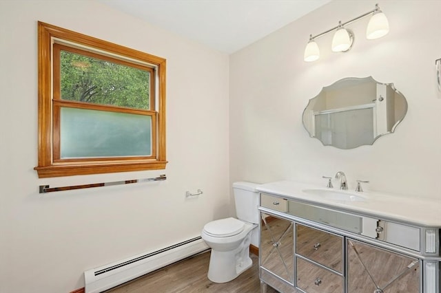 45 Dillon St, Worcester, MA 01604 - bathroom with a baseboard radiator, vanity, toilet, and wood finished floors