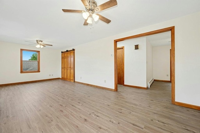 45 Dillon St, Worcester, MA 01604 - spare room with ceiling fan, a barn door, light wood-type flooring, and a baseboard heating unit
