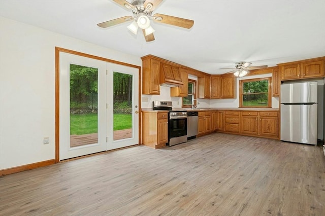 45 Dillon St, Worcester, MA 01604 - kitchen with stainless steel appliances, a ceiling fan, light wood-style floors, and light countertops