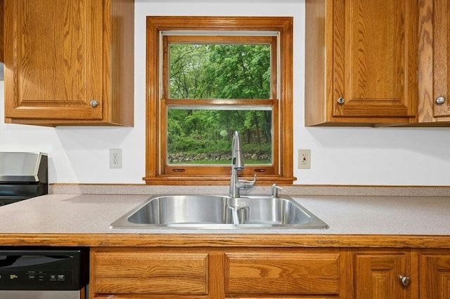 45 Dillon St, Worcester, MA 01604 - kitchen with a sink, dishwashing machine, brown cabinets, and light countertops