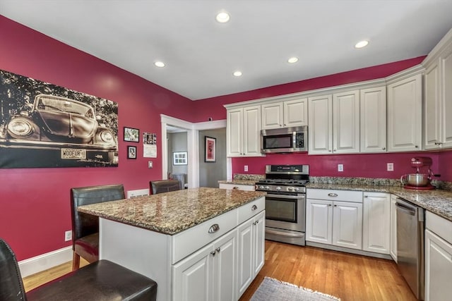 kitchen featuring white cabinetry, appliances with stainless steel finishes, and stone countertops