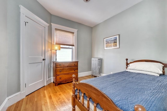 bedroom with radiator and light wood-type flooring