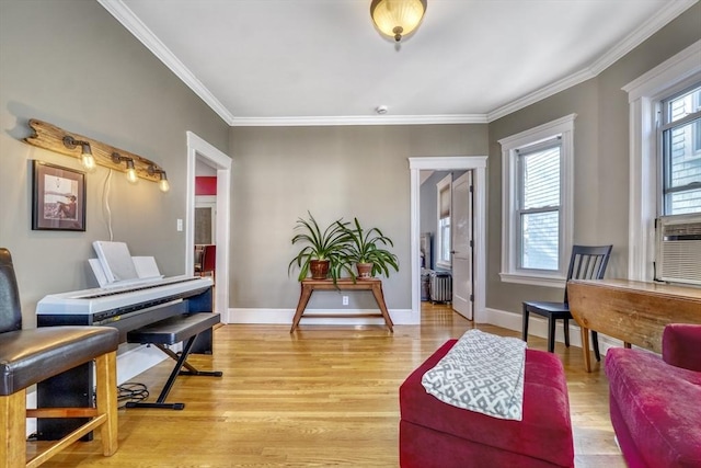 living area with crown molding, radiator heating unit, and light wood-type flooring