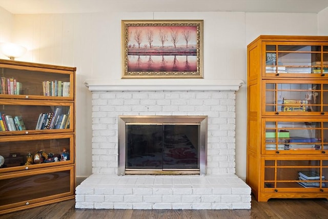 detailed view of a brick fireplace and wood finished floors
