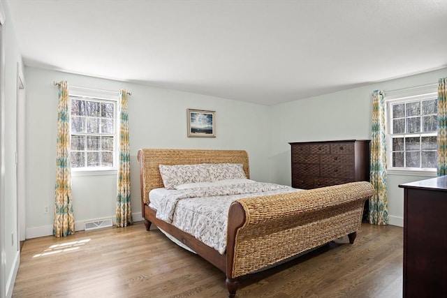 bedroom featuring wood finished floors and baseboards