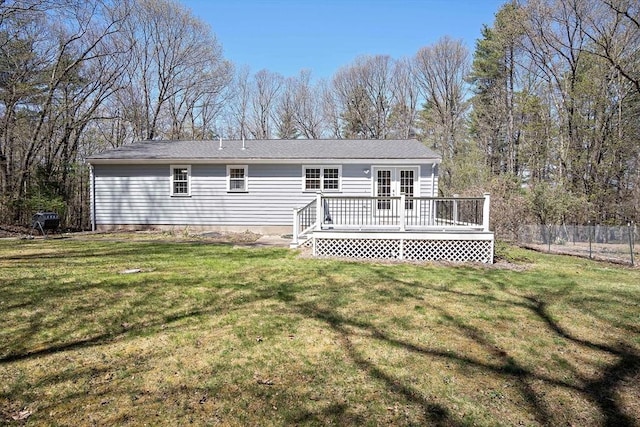 rear view of house with a deck and french doors