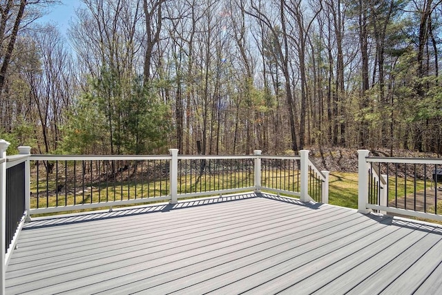 wooden deck featuring a forest view
