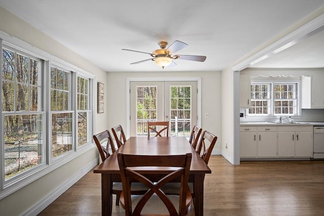 dining area with plenty of natural light, baseboards, and dark wood-type flooring