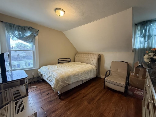 bedroom with dark wood-type flooring, baseboards, vaulted ceiling, and baseboard heating