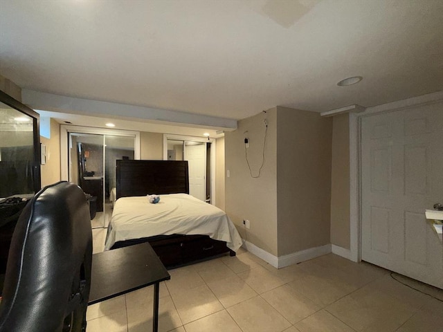 bedroom featuring light tile patterned flooring and baseboards