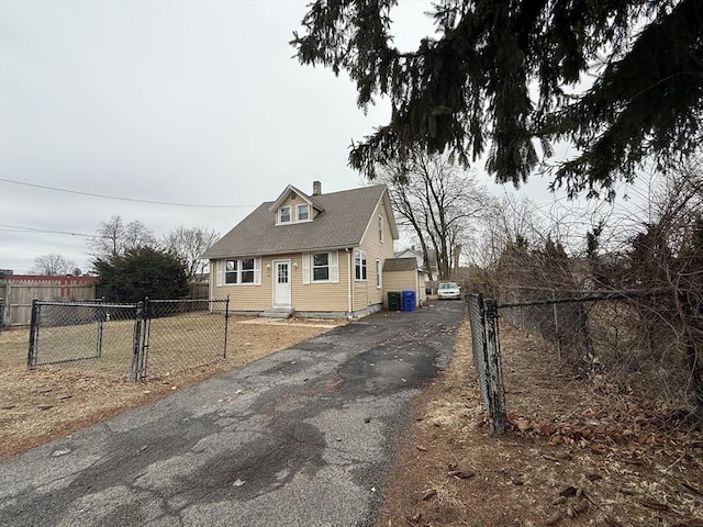 view of front of house with entry steps, a gate, central AC, and fence