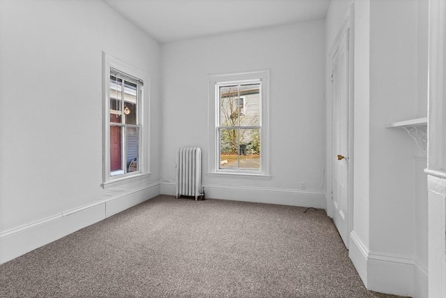 carpeted spare room with radiator