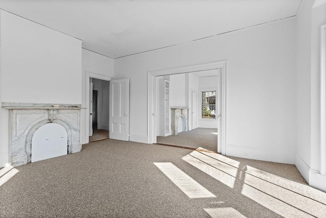 unfurnished living room featuring carpet floors