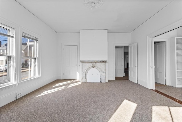 unfurnished living room featuring carpet floors