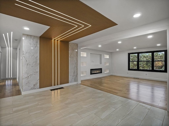 820 N King St, Northampton, MA 01060 - unfurnished living room with recessed lighting, a glass covered fireplace, and wood finished floors