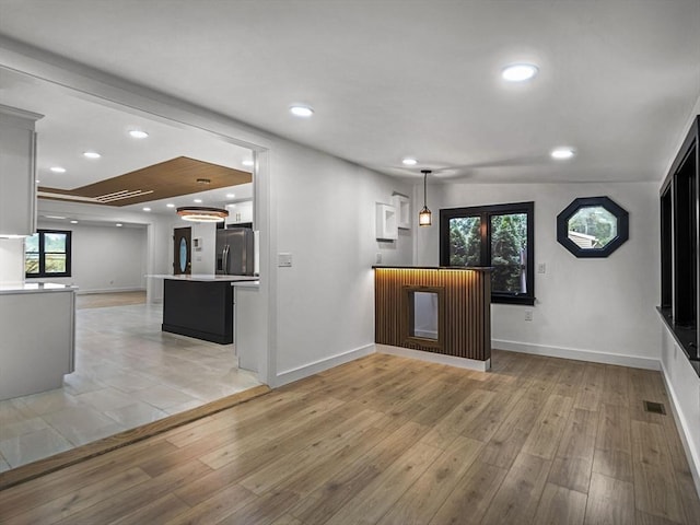 820 N King St, Northampton, MA 01060 - kitchen featuring stainless steel refrigerator with ice dispenser, open floor plan, light wood-style floors, light countertops, and recessed lighting