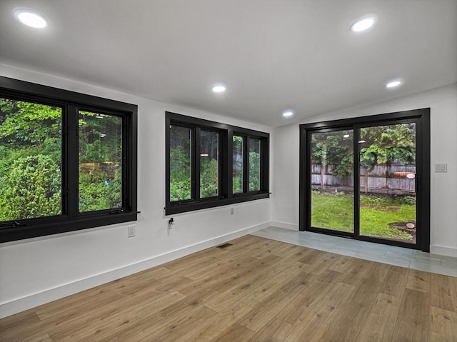 820 N King St, Northampton, MA 01060 - empty room featuring wood finished floors, recessed lighting, plenty of natural light, and lofted ceiling