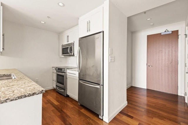10 Nouvelle Way Unit S703, Natick, MA 01760 - kitchen featuring appliances with stainless steel finishes, dark wood-style flooring, white cabinetry, light stone countertops, and recessed lighting
