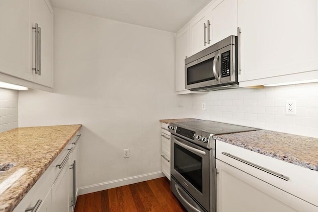 10 Nouvelle Way Unit S703, Natick, MA 01760 - kitchen with stainless steel appliances, dark wood-style floors, baseboards, tasteful backsplash, and white cabinetry