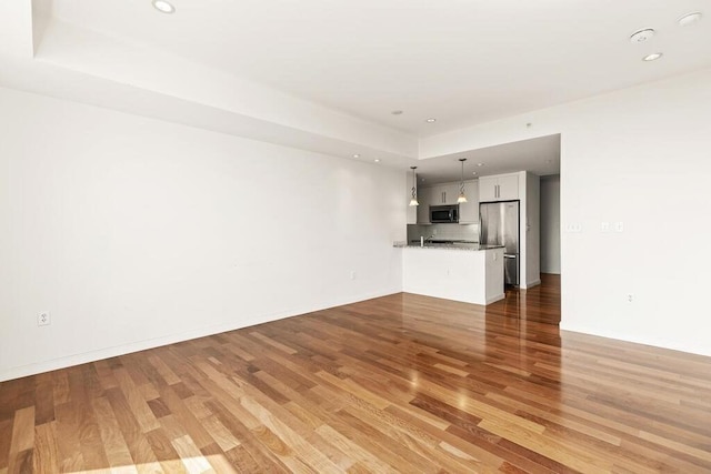 10 Nouvelle Way Unit S703, Natick, MA 01760 - unfurnished living room featuring light wood-style floors, recessed lighting, and baseboards