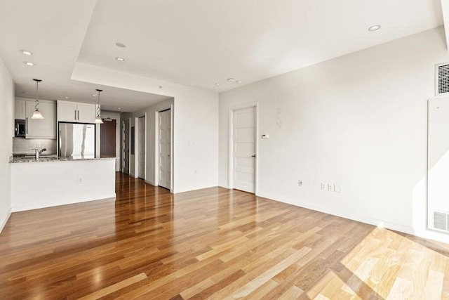10 Nouvelle Way Unit S703, Natick, MA 01760 - unfurnished living room with light wood-type flooring, recessed lighting, and a sink