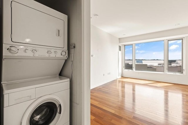10 Nouvelle Way Unit S703, Natick, MA 01760 - laundry room featuring estacked washer and dryer, wood finished floors, and baseboards