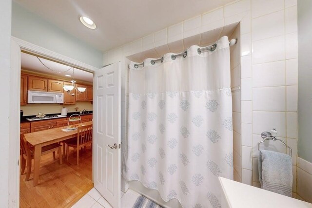 full bath with a shower with curtain and a sink